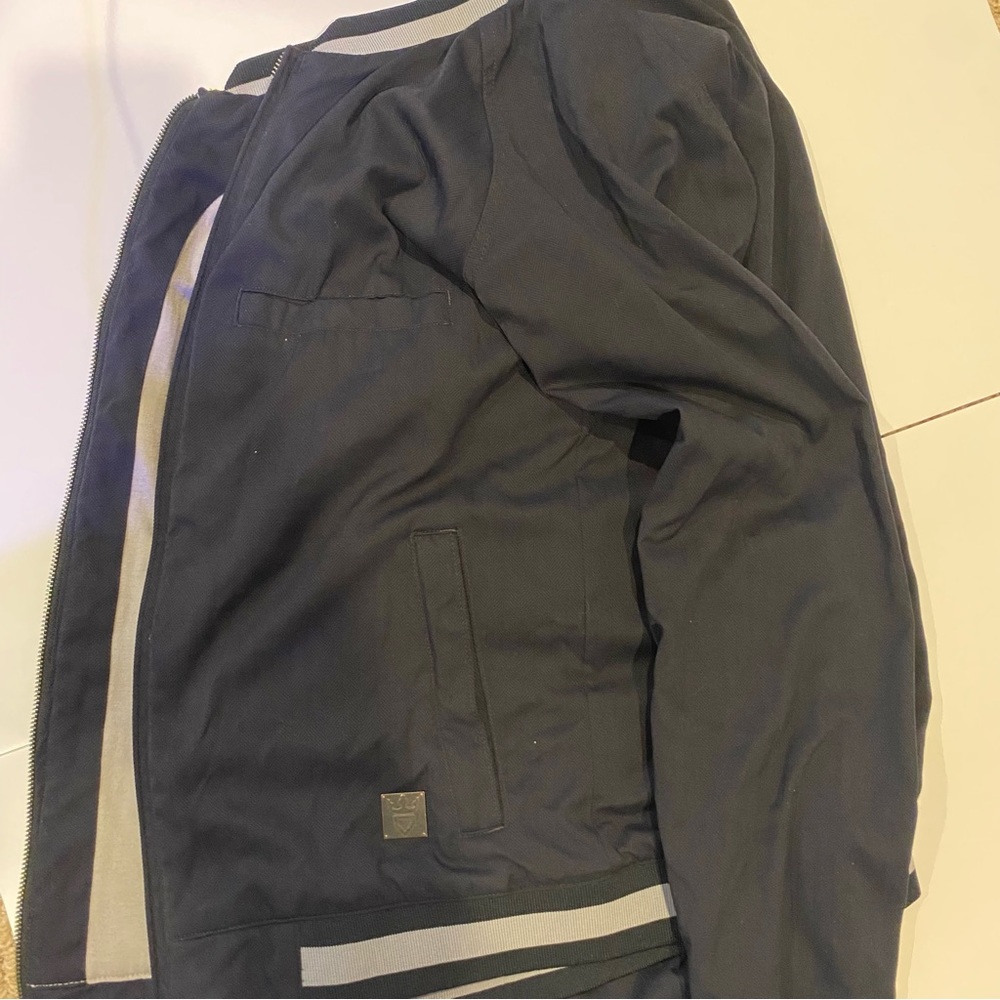 Demarini, Black Jacket, two pockets. Size Adult Small.